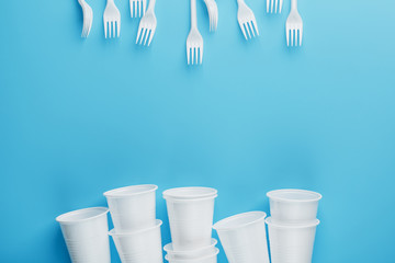 Dishes made of white plastic on a blue background.