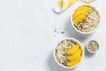 Oatmeal citrus porridge, healthy breakfast. Top view, copy space.