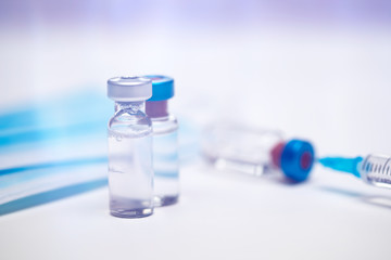 Close up on vaccine and medical syringe