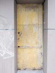 old metal door painted yellow rust corrode