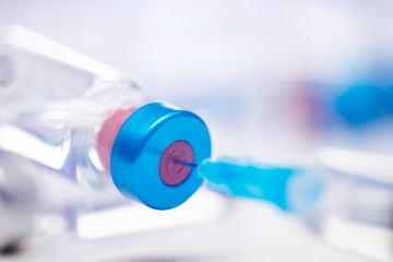 Close up on vaccine and medical syringe