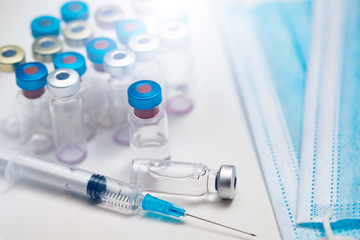 Close up on vaccine and medical syringe