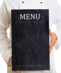 Fototapeta na wymiar Chef, waiter wearing white uniform, holds a blank menu board, standing on white background.