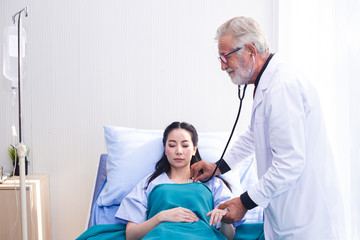 man doctor using stethoscope health check for women patients in hospital.