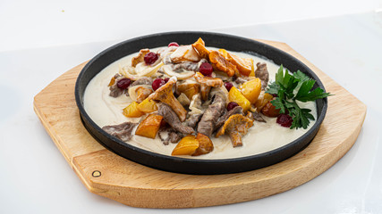 fried potatoes with chanterelles in a creamy sauce