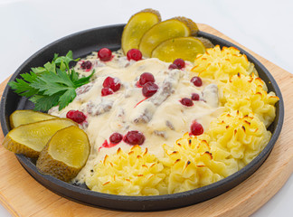 beef in cream sauce with mashed potato roses