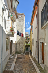 A narrow street between the old houses of the village of Pietraroja, in the province of Benevento, Italy