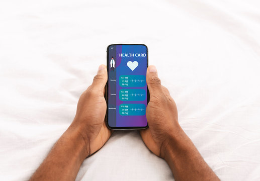 Guy showing phone with online medical services on screen