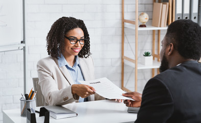 HR manager interviewing young African American candidate in office. Panorama