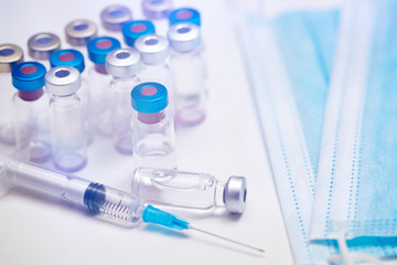 Close up on vaccine and medical syringe