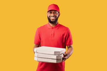 Pizzeria Courier Man Delivering Pizza Standing On Yellow Studio Background