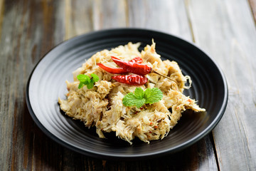 Northern Thai food (Tam Khanun), spicy pounded young jackfruit salad on wooden background