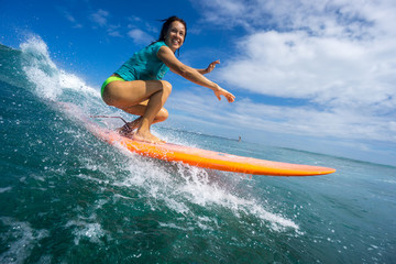 beautiful girl surfing on big transparent waves - obrazy, fototapety, plakaty