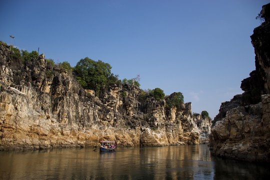 Jabalpur, Madhya Pradesh/India : January 28, 2020 - Tourists riding in small wooden boat on Narmada river at Bhedaghat, Jabalpur
