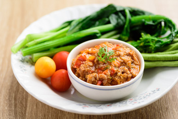 Northern Thai food (Nam Prik Ong), spicy chili minced pork with tomatoes eating with vegetables, Thai chili paste