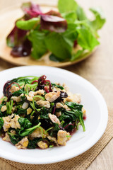 Stir fried Thai spinach with egg on white dish with spoon ready to eating, Healthy Thai food