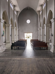 Fototapeta premium interior of church from the altar looking back past the pews through the entrance doors