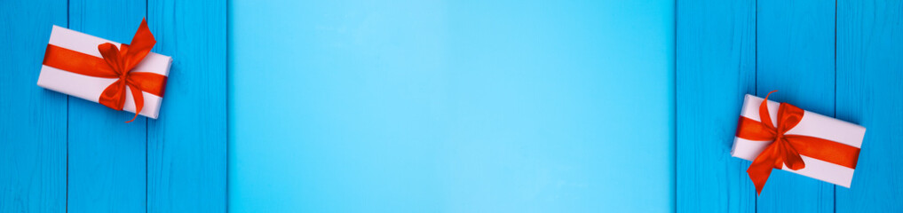 Flat lay. White gift wrapping lies on a wooden blue background, against each other. Gift for birthday, Christmas, Valentine's day, New year. Congratulations to the copy background space.