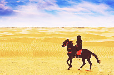 Bedouin ride horse at Sahara desert in Tunisia