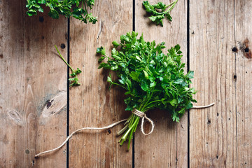 Fresh parsley on a wooden rustic background.