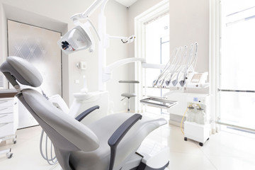 Dentist tools and professional dentistry chair in modern clinic