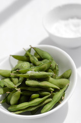 edamame beans snack in bowl on table with sea salt