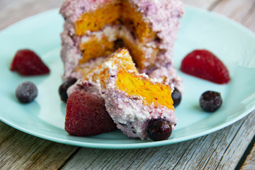 Carrot cake with curd cream and black currant