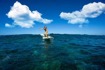 young beautiful girl surf on the big waves in the open ocean. Mauritius Island