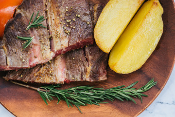 Grilled rib eye beef steak with herbs and spices on a stone background with copy space for your text.  focus on Grilled wagyu beef.

