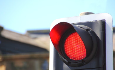 Close up of red traffic stop light in finance area of city 