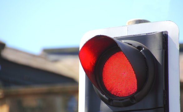 Close up of red traffic stop light in city 