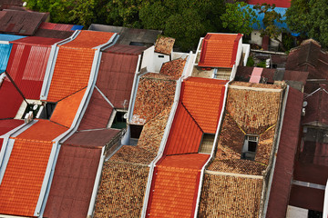 view of the roof and rows of shophouses in the old town from the top of the hotel Neo in George...