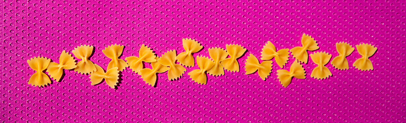 pop art pasta farfalle on pink background