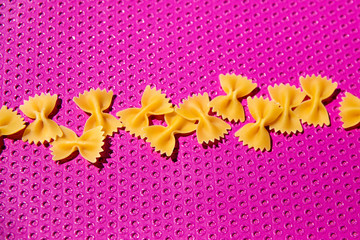 pop art pasta farfalle on pink background
