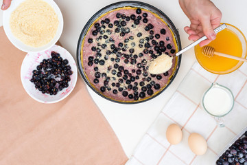 the stages of preparation of a pie with black currants and shortbread crust , fresh berries. the view from the top .