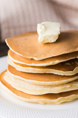 Pile of tasty pancakes with butter. Breakfast concept.