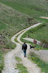 Fototapeta premium Young Woman whit your dog in Montaup river in Canillo, Andorra in spring