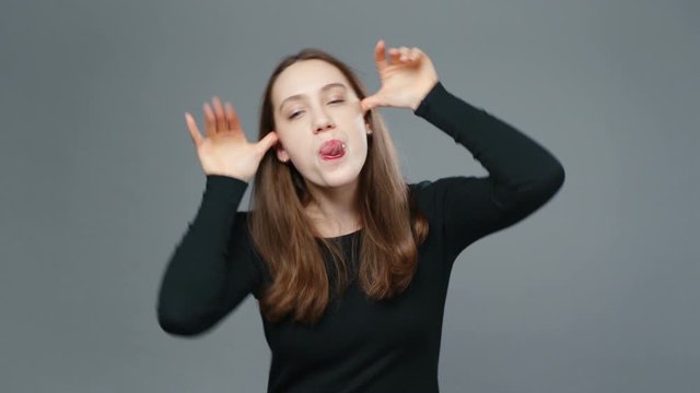 Video of grimacing girl in black shirt