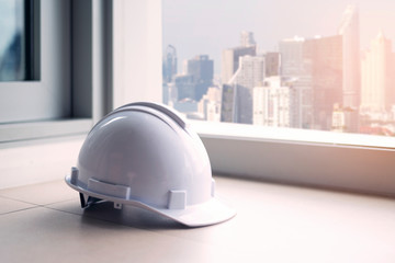 Engineer helmet is putting with architect building at the background as for industrial engineer.