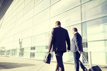 Portrait of businessmen walking in airport