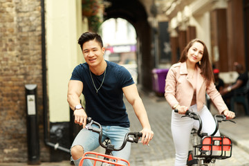 young couple enjoying a bike ride together