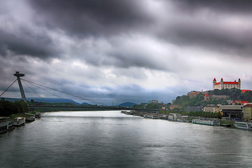 Cityscape of Bratislava city with the SNP bridge (UFO bridge) over Danube river and old castle,....