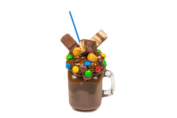 Chocolate milkshake with whipped cream, cookies, waffles, served in glass mason jar. 
