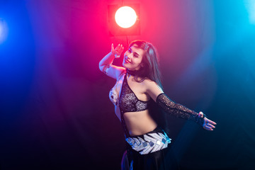 Belly dancer. Young attractive woman dancing tribal fusion on the stage. Oriental exotic dance.