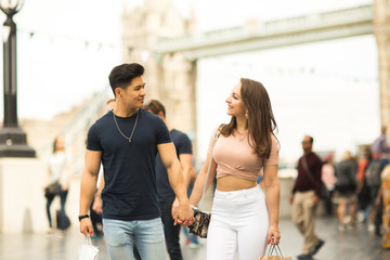 a young couple walking together by tower bridge