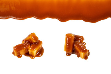 Background of flowing caramel sauce isolated on white.
