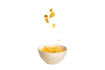 Corn flakes falling to the white bowl. Motion.