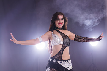 Young woman dancing in Tribal Fusion style. Belly dance on the stage.