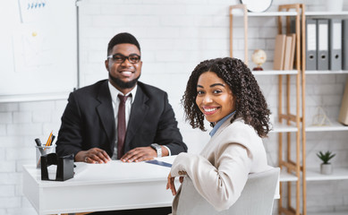 Happy personnel manager and African American vacancy candidate on job interview in office