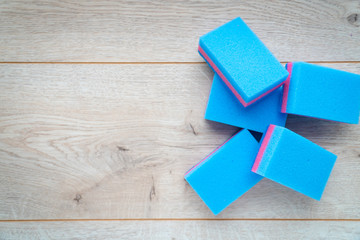  Kitchen rags and sponges on a wooden background